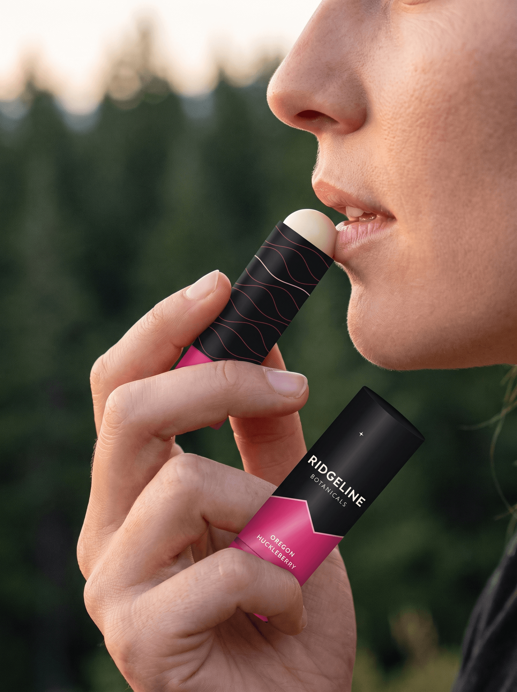 Applying Oregon Huckleberry lip balm outdoors at dusk
